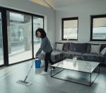 Aide ménagère à domicile nettoyant un salon